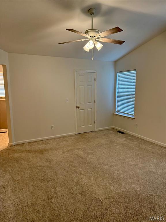 51 Tower St, Moscow Mills, MO 63362 - carpeted spare room with a ceiling fan and lofted ceiling