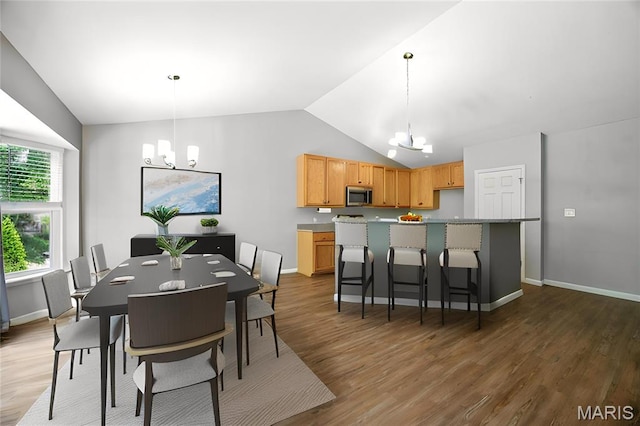 1161 Foxwood Estates Dr, Arnold, MO 63010 - dining space featuring a chandelier, lofted ceiling, and wood finished floors