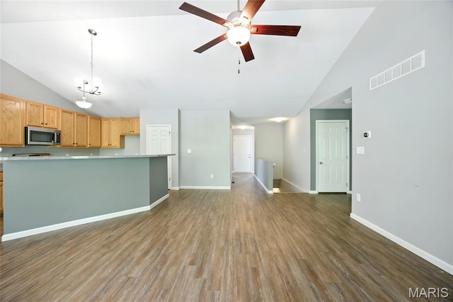 1161 Foxwood Estates Dr, Arnold, MO 63010 - kitchen featuring stainless steel microwave, ceiling fan, wood finished floors, light countertops, and open floor plan
