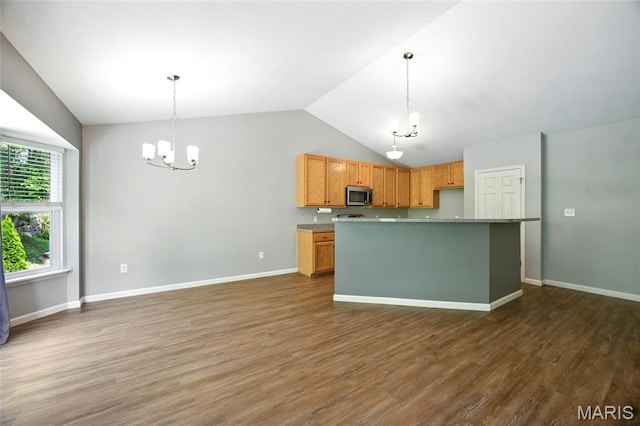 1161 Foxwood Estates Dr, Arnold, MO 63010 - kitchen with stainless steel microwave, a chandelier, lofted ceiling, dark wood-style flooring, and pendant lighting