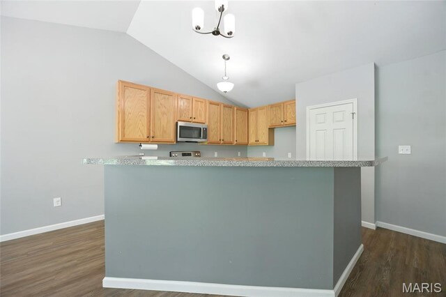 1161 Foxwood Estates Dr, Arnold, MO 63010 - kitchen with stainless steel microwave, vaulted ceiling, light countertops, dark wood finished floors, and decorative light fixtures
