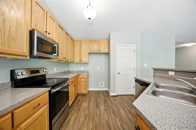 1161 Foxwood Estates Dr, Arnold, MO 63010 - kitchen featuring stainless steel appliances, wood finished floors, light brown cabinets, and light countertops