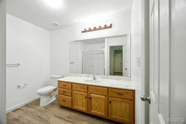1161 Foxwood Estates Dr, Arnold, MO 63010 - full bath featuring vanity, wood finished floors, and a shower with door