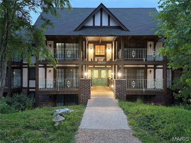 1420 Heritage Lndg Unit 107, Saint Charles, MO 63303 - view of front of house with french doors, a shingled roof, a balcony, and a porch