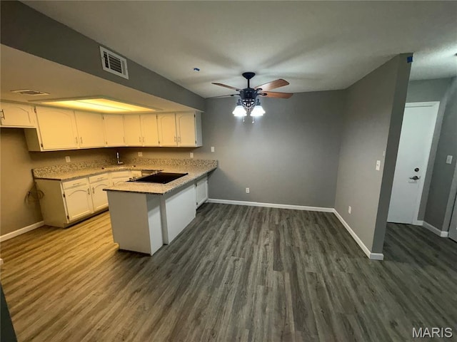 1420 Heritage Lndg Unit 107, Saint Charles, MO 63303 - kitchen with a peninsula, white cabinetry, dark wood-style flooring, ceiling fan, and black electric cooktop