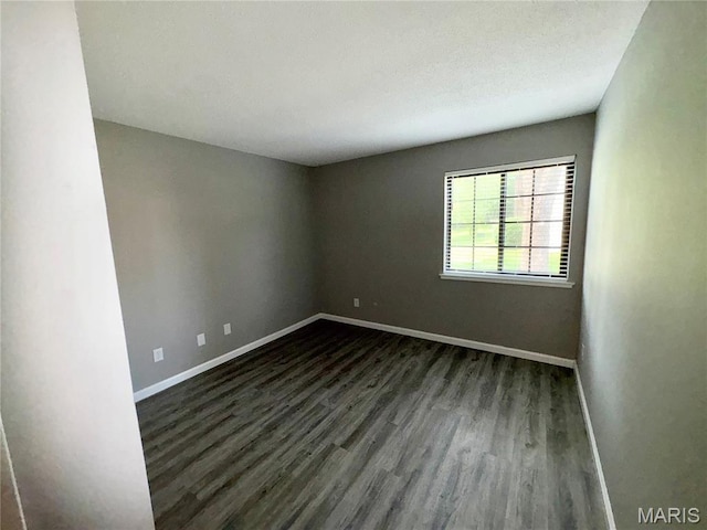 1420 Heritage Lndg Unit 107, Saint Charles, MO 63303 - unfurnished room with dark wood-style floors and baseboards