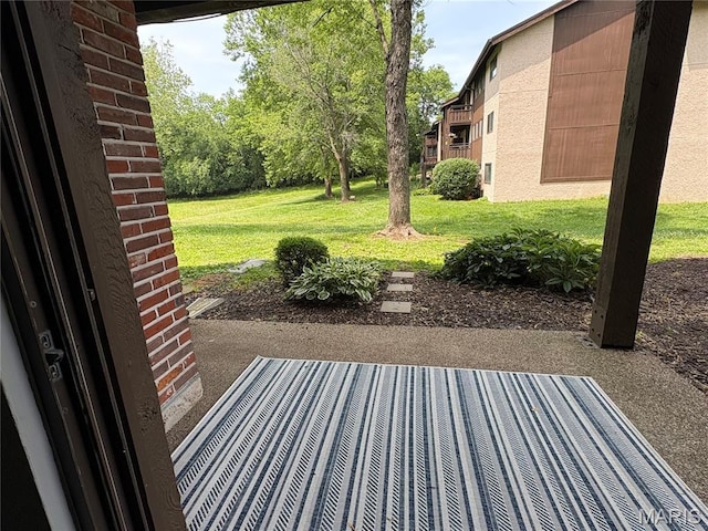 1420 Heritage Lndg Unit 107, Saint Charles, MO 63303 - view of grassy yard with a patio area