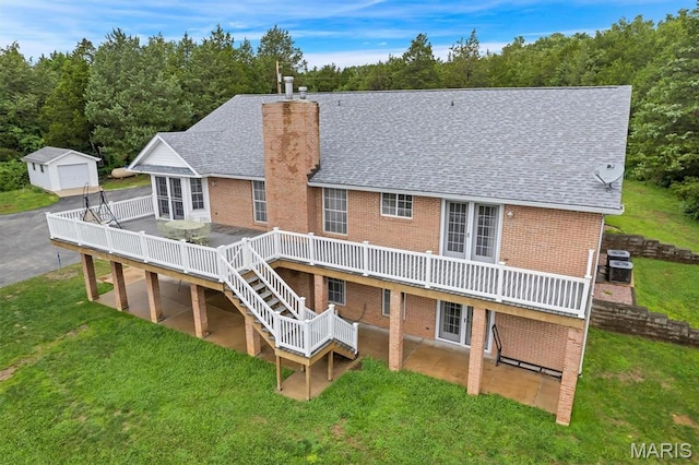 2518 Nike Base Rd, Catawissa, MO 63015 - rear view of house with brick siding, a wooden deck, a chimney, roof with shingles, and a lawn