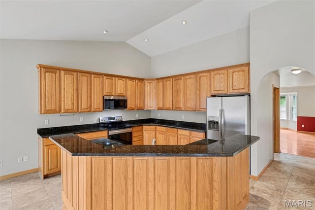 2518 Nike Base Rd, Catawissa, MO 63015 - kitchen with stainless steel appliances, arched walkways, high vaulted ceiling, dark stone counters, and light tile patterned floors