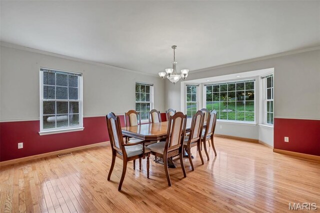 2518 Nike Base Rd, Catawissa, MO 63015 - dining space featuring a chandelier, light wood-style floors, and ornamental molding