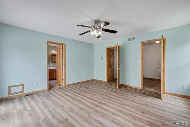2518 Nike Base Rd, Catawissa, MO 63015 - unfurnished bedroom with light wood-style flooring, connected bathroom, and ceiling fan