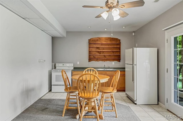 2518 Nike Base Rd, Catawissa, MO 63015 - kitchen featuring white appliances, dark countertops, light tile patterned floors, and ceiling fan