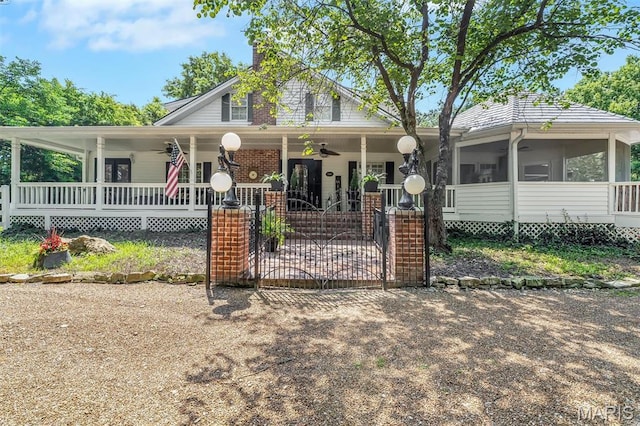 2466 State Road Ff, Eureka, MO 63025 - country-style home featuring ceiling fan, a porch, a chimney, a sunroom, and a gate