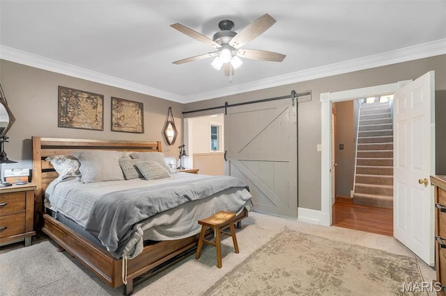 2466 State Road Ff, Eureka, MO 63025 - bedroom with ornamental molding, a barn door, a ceiling fan, and light carpet