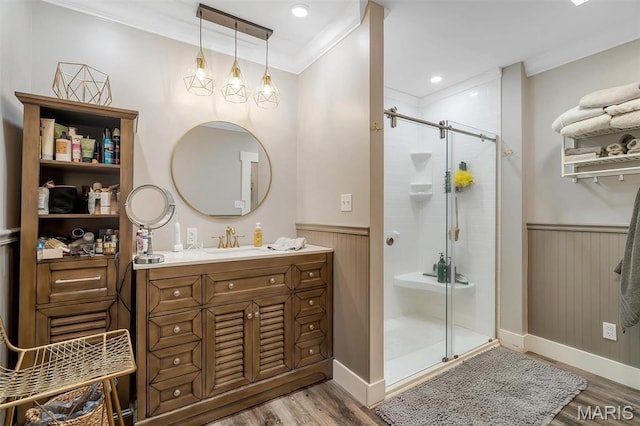 2466 State Road Ff, Eureka, MO 63025 - bathroom featuring crown molding, wood finished floors, vanity, wainscoting, and a stall shower