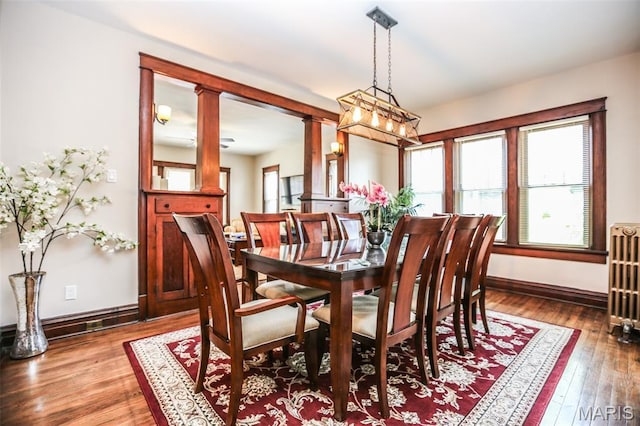 201 S Columbus St, Pacific, MO 63069 - dining space featuring wood-type flooring, radiator, and ornate columns