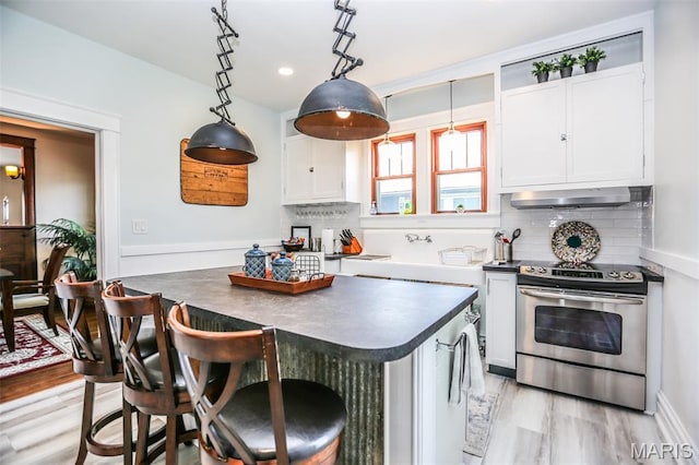 201 S Columbus St, Pacific, MO 63069 - kitchen featuring electric stove, dark countertops, range hood, a center island, and recessed lighting