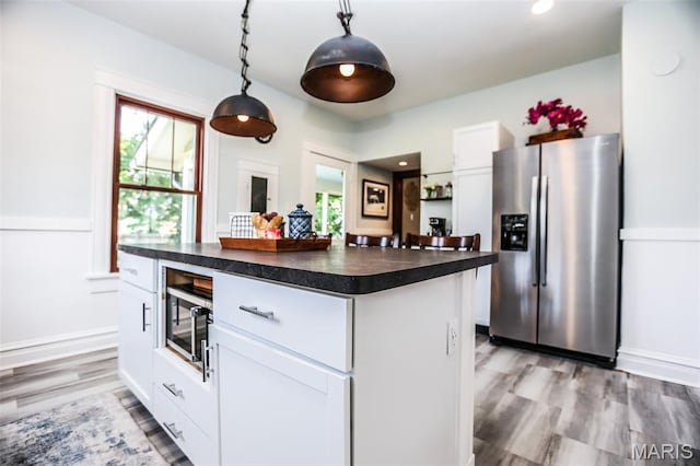 201 S Columbus St, Pacific, MO 63069 - kitchen featuring stainless steel refrigerator with ice dispenser, dark countertops, plenty of natural light, white cabinets, and recessed lighting