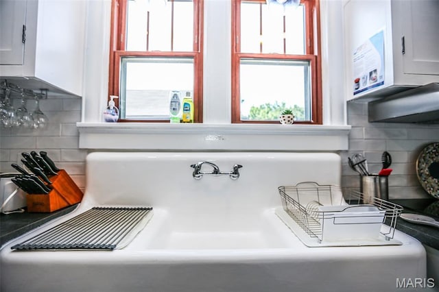 201 S Columbus St, Pacific, MO 63069 - kitchen view of backsplash, white cabinetry, and dark countertops