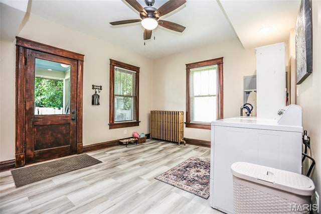 201 S Columbus St, Pacific, MO 63069 - bathroom with radiator, washer / dryer, healthy amount of natural light, and wood finished floors