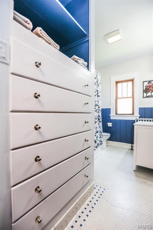 201 S Columbus St, Pacific, MO 63069 - bathroom with vanity, a wainscoted wall, and a shower with curtain