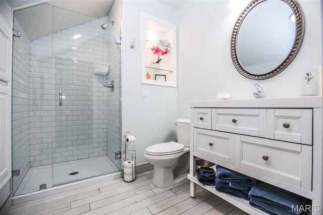201 S Columbus St, Pacific, MO 63069 - bathroom with vanity, a shower stall, and wood finished floors