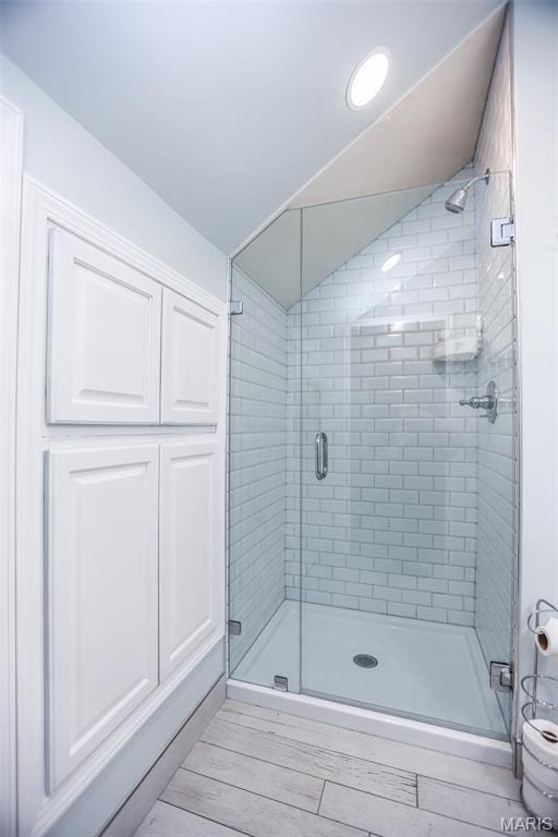 201 S Columbus St, Pacific, MO 63069 - full bathroom featuring a shower stall, wood finished floors, and vaulted ceiling