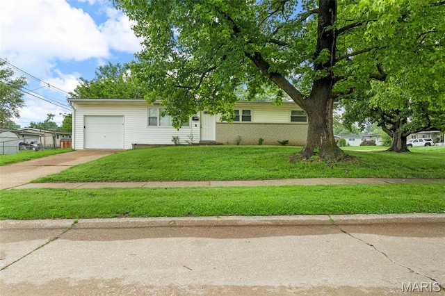 2185 Orleans Ln, Florissant, MO 63031 - ranch-style house with an attached garage, concrete driveway, a front lawn, and brick siding