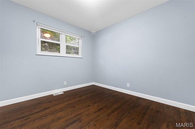 2185 Orleans Ln, Florissant, MO 63031 - unfurnished room featuring baseboards and dark wood-style floors