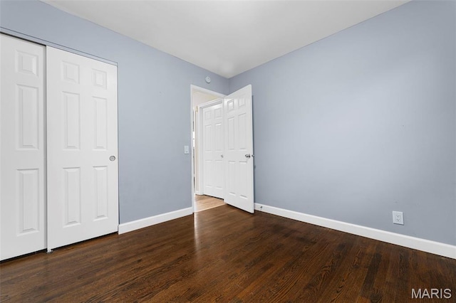 2185 Orleans Ln, Florissant, MO 63031 - unfurnished bedroom featuring wood finished floors and a closet