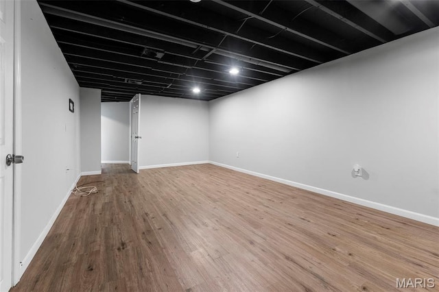2185 Orleans Ln, Florissant, MO 63031 - finished basement featuring wood finished floors and baseboards