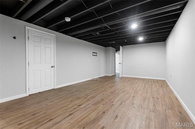 2185 Orleans Ln, Florissant, MO 63031 - finished below grade area with light wood-style flooring and baseboards