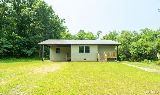 201 W 5th St, Grandin, MO 63943 - back of house featuring a yard, a carport, crawl space, a wooden deck, and view of scattered trees