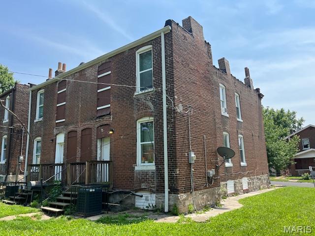 2923 Miami, Saint Louis, MO 63118 - view of side of home featuring brick siding, a lawn, and a chimney