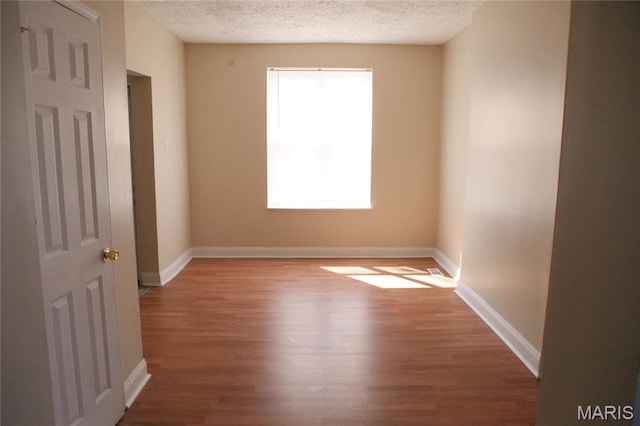 2923 Miami, Saint Louis, MO 63118 - empty room featuring a textured ceiling and wood finished floors