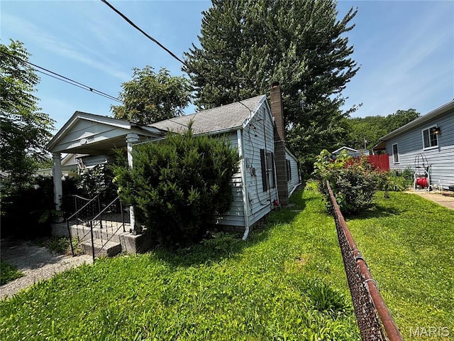 2205 N 5th St, Saint Charles, MO 63301 - view of side of home with a yard and a chimney