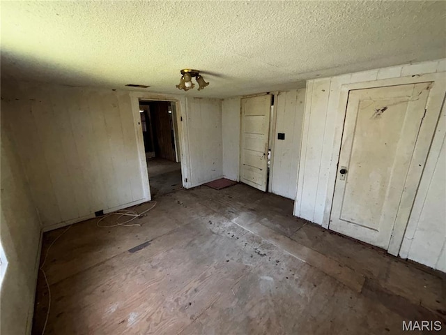 2205 N 5th St, Saint Charles, MO 63301 - unfurnished room with a textured ceiling and wooden walls