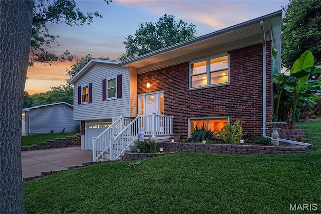1809 Partridge Dr, Windsor Township, MO 63052 - bi-level home with brick siding, a garage, concrete driveway, and a yard