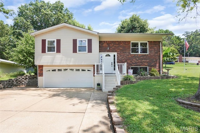 1809 Partridge Dr, Windsor Township, MO 63052 - split foyer home with a garage, concrete driveway, brick siding, and a front lawn