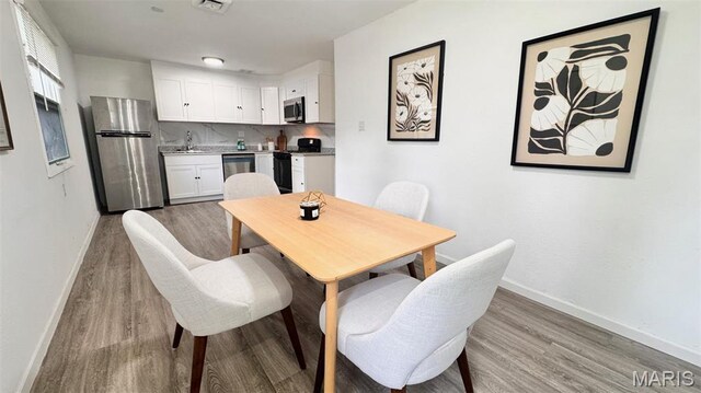 3553 Mckibbon Rd, Saint Louis, MO 63114 - dining area featuring baseboards and wood finished floors