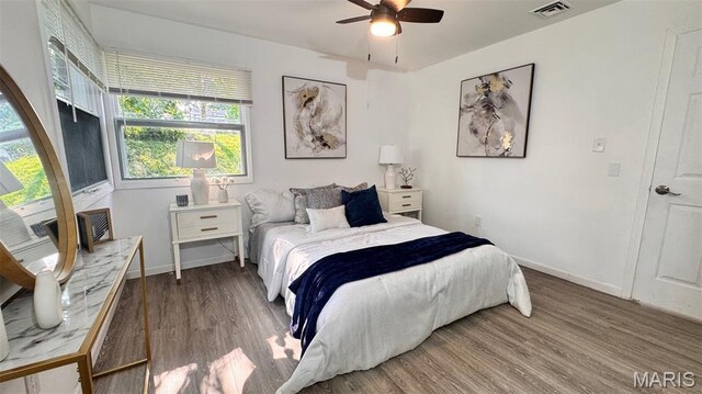 3553 Mckibbon Rd, Saint Louis, MO 63114 - bedroom with wood finished floors, multiple windows, and ceiling fan
