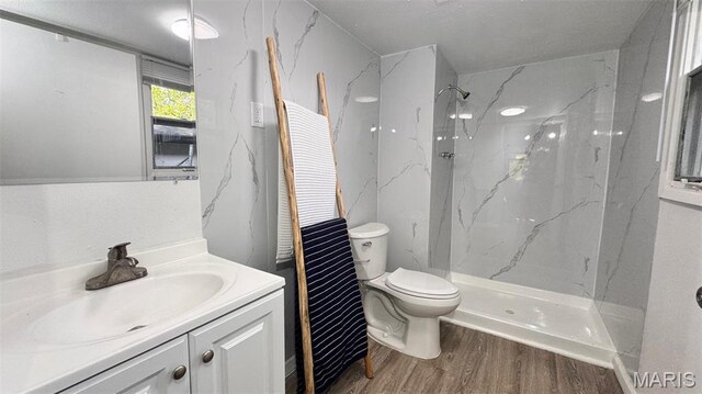 3553 Mckibbon Rd, Saint Louis, MO 63114 - full bathroom with wood finished floors, vanity, and a marble finish shower
