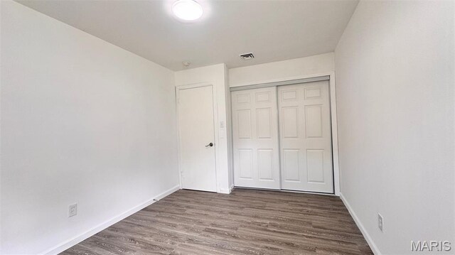 3553 Mckibbon Rd, Saint Louis, MO 63114 - unfurnished bedroom featuring a closet and wood finished floors