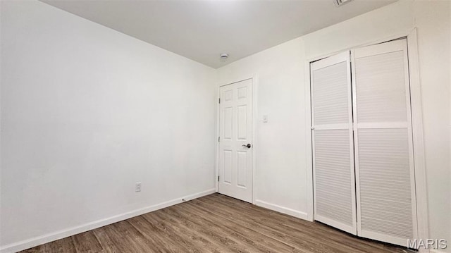 3553 Mckibbon Rd, Saint Louis, MO 63114 - unfurnished bedroom featuring wood finished floors and a closet