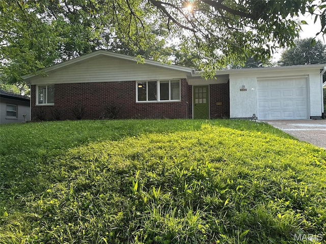 3553 Mckibbon Rd, Saint Louis, MO 63114 - ranch-style home featuring a garage, a front yard, asphalt driveway, and brick siding