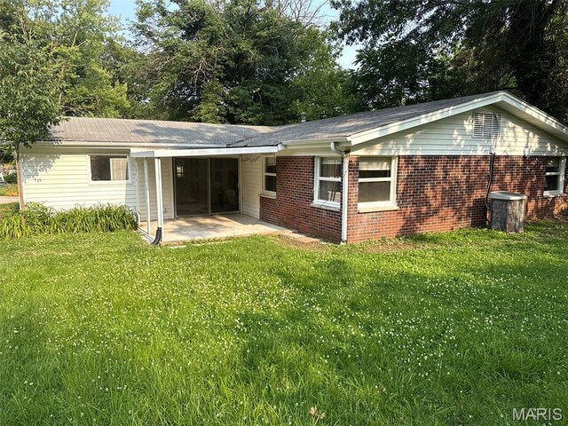 3553 Mckibbon Rd, Saint Louis, MO 63114 - back of house with a patio, a lawn, and brick siding