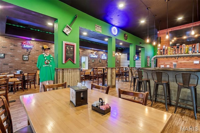 201 Houser St, Park Hills, MO 63601 - dining area with brick wall, wood finished floors, and a community bar