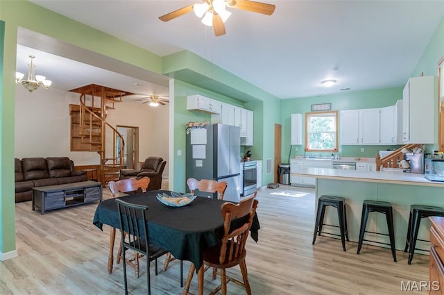 10201 County Road 5440, Rolla, MO 65401 - dining room with stairway, light wood finished floors, ceiling fan, and a chandelier