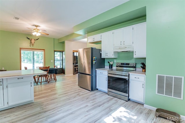 10201 County Road 5440, Rolla, MO 65401 - kitchen featuring stainless steel appliances, under cabinet range hood, light wood-style flooring, white cabinets, and light countertops