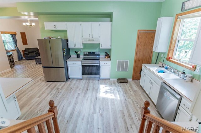 10201 County Road 5440, Rolla, MO 65401 - kitchen featuring stainless steel appliances, under cabinet range hood, light wood-style flooring, and light countertops